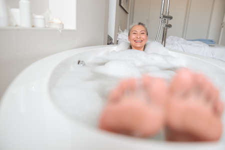 Happy lady resting in hotel after workの写真素材