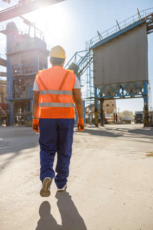 Young worker dressed in safety equipment inside factoryの写真素材