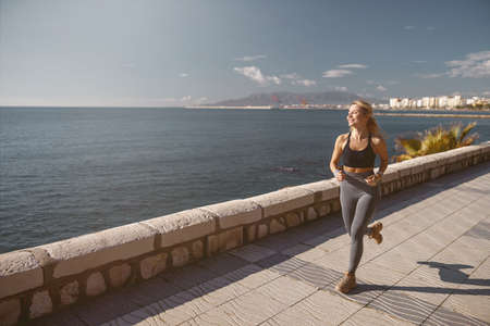 Shot of beautiful fitness woman on street workoutの素材 [FY310182152401]