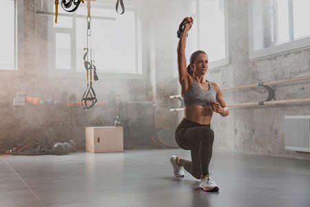 Young woman going in for sport at fitness clubの写真素材