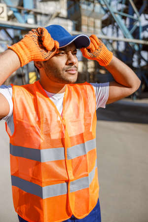 Serious construction worker observing construction site of plantの写真素材