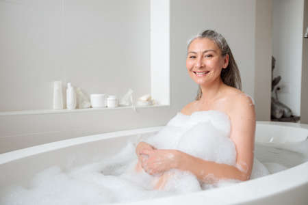 Positive adult woman resting after work in spaの写真素材