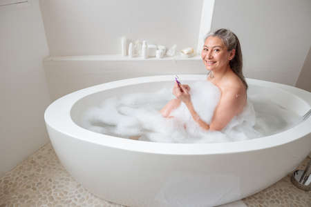 Lady preparing to remove leg hair. Skincare and healthの写真素材