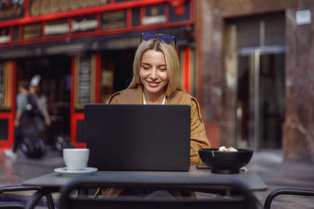 Woman studying something while looking at laptop screenの写真素材