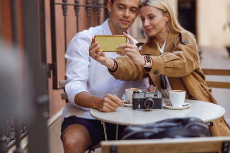 Close-up of woman holding smartphone while taking selfieの写真素材