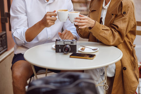 Man and woman having coffee at outdoors cafeの写真素材