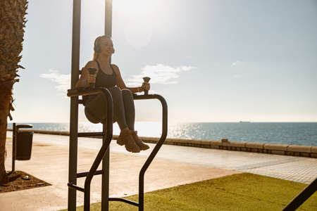 Young athletic woman exercising at city parkの写真素材