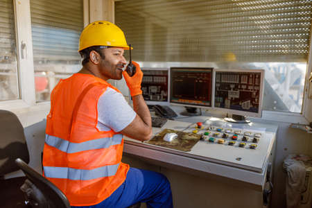 Young man working hard at heavy industry plantの写真素材