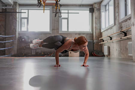 Beautiful woman doing yoga alone at gymの写真素材