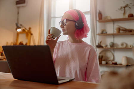 Female potter working online in pottery workshopの写真素材