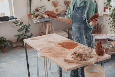 Ceramist woman preparing clay to make pottery pieces in studioの写真素材