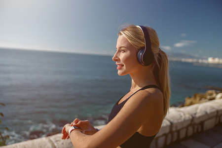 Attractive young woman looking at beautiful coastline
