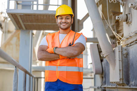 Smiling young construction engineer working in plantの写真素材