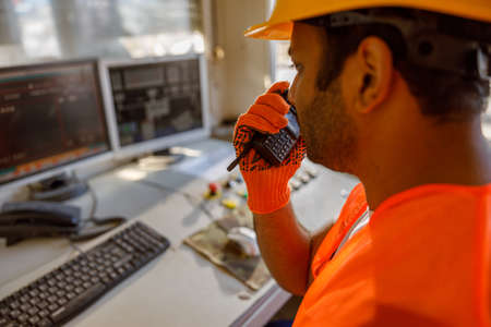 Foreman with safety equipment working at construction plant