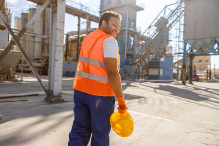 Photo of man working hard at construction material factoryの写真素材