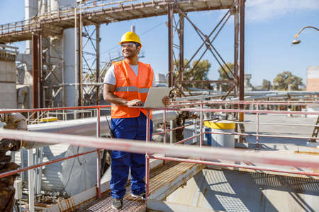 Worker with safety equipment working at heavy industry plantの写真素材