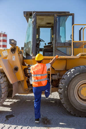Experienced construction worker using truck at factoryの写真素材