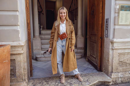 Full-length photo of woman standing at the entrance to buildingの写真素材