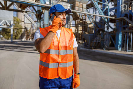 Photo of man working hard at construction industry plant