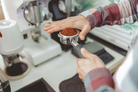Close up of man hands holding portafilterの写真素材