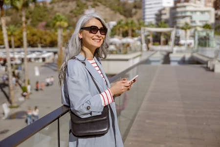 Portrait of beautiful Asian lady standing outdoorsの写真素材