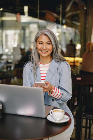 Confident female with happy face posing indoorsの写真素材