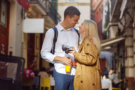 Man and woman standing on street and looking at each other
