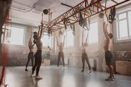 Team of sporty people training in fitness clubの写真素材