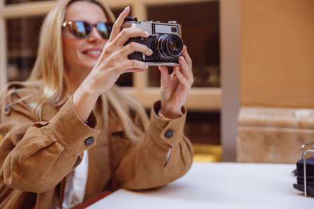 Close-up of woman hands holding retro cameraの写真素材