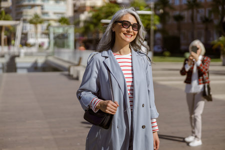 Well dressed female taking stroll through cityの写真素材