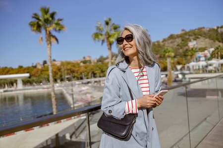 Happy and healthy woman enjoying good day outdoorsの写真素材