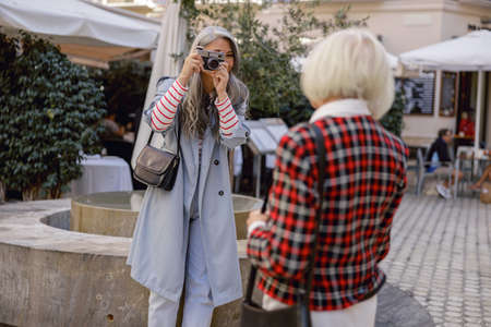 Happy female friends strolling down city centerの写真素材