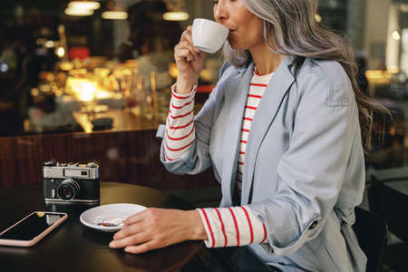 Good looking female resting at street cafeの写真素材