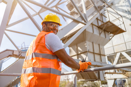 African male engineer inspecting site at construction plantの写真素材