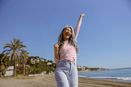 Healthy inspired female walking outdoors along seashoreの写真素材