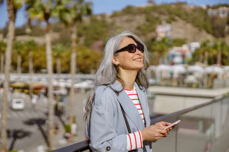 Happy and healthy woman enjoying good day outdoorsの写真素材