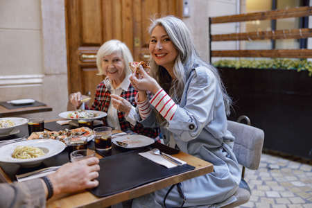Cheerful women chatting and laughing in cafeの写真素材