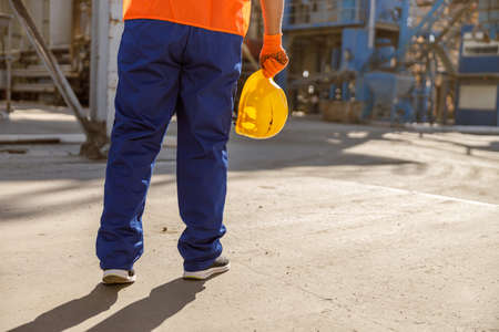 Frustrated foreman with hard hat in factoryの写真素材