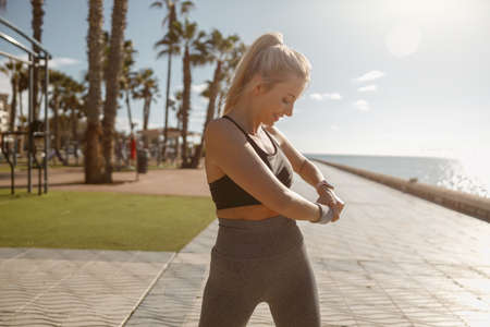 Fit young woman exercising near beautiful coastlineの写真素材