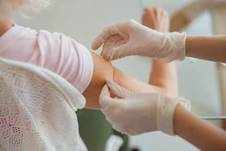 Young nurse visiting elderly patient at homeの写真素材