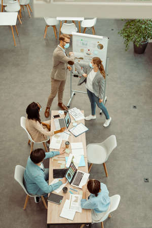 Two colleagues standing in the meeting room in the officeの写真素材