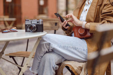 Photographer resting after work and writing message
