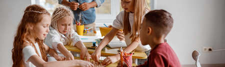 Happy schoolchildren are using wooden math tabletの写真素材