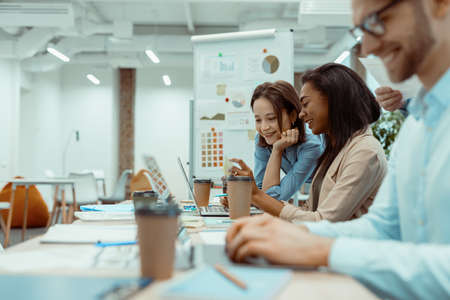 Creative business team using laptop in officeの写真素材