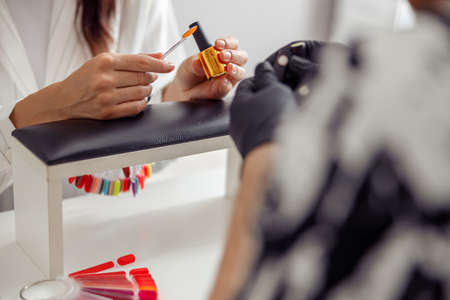 Woman client having nail manicure in nail art studioの写真素材