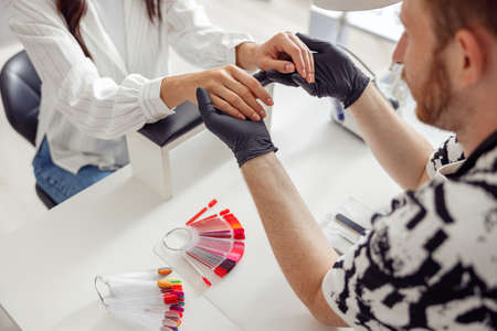 Woman client having nail manicure in nail art studioの写真素材
