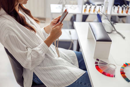 Elegant woman choosing polish colour in salonの写真素材
