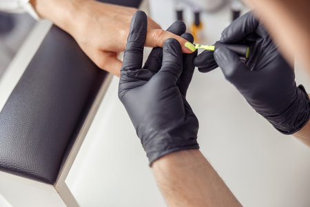 Proffesional manicure master working on nails in salonの写真素材