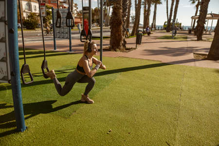 Caucasian athletic woman exercising at city parkの写真素材