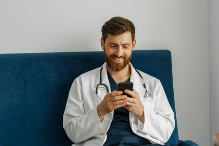 Doctor therapist use phone during break in medicine officeの写真素材